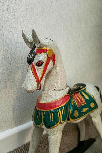 a figurine of a toy horse sitting on the floor at Kings Lodge in Torquay