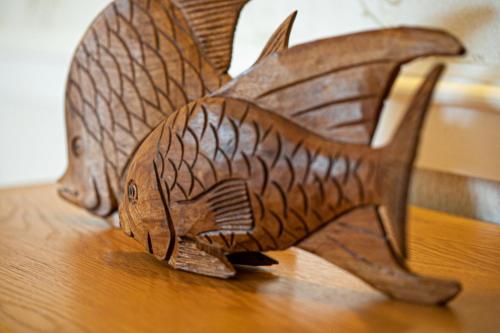 a wooden carving of a fish on a table at Kings Lodge in Torquay