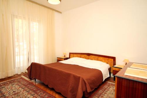 a bedroom with a bed and a large window at Apartments by the sea Tkon, Pasman - 822 in Tkon
