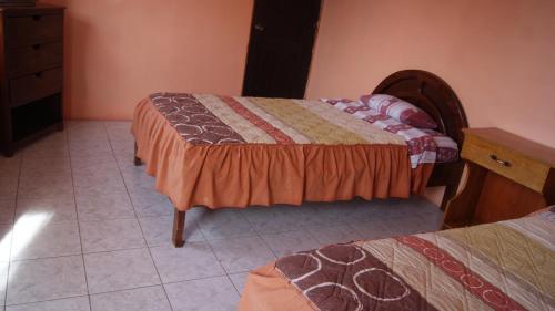 a bedroom with two beds and a dresser at Zumag Sisa in Tena