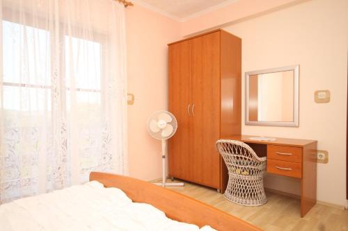 a bedroom with a bed and a dresser and a mirror at Apartment Kali 834a in Kali