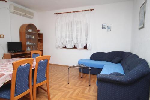 a living room with a couch and a table at Apartments by the sea Kali, Ugljan - 834 in Kali