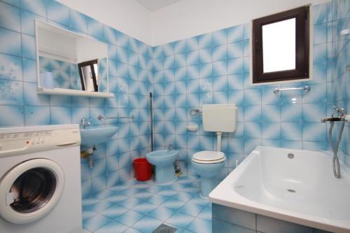 a blue tiled bathroom with a toilet and a sink at Apartments with a parking space Sali, Dugi otok - 872 in Sali