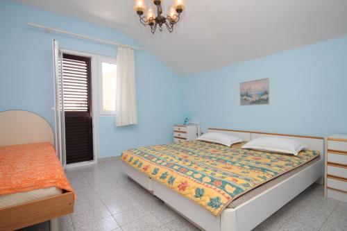a blue bedroom with a bed and a window at Apartments with a parking space Sali, Dugi otok - 872 in Sali