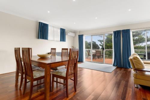 a dining room with a wooden table and chairs at Warley Retreat in Cowes