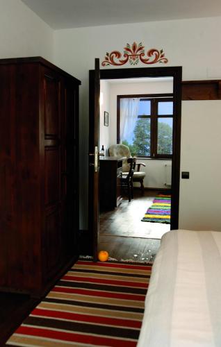 a bedroom with a door leading to a living room at Family Hotel Arkan Han in Trigrad