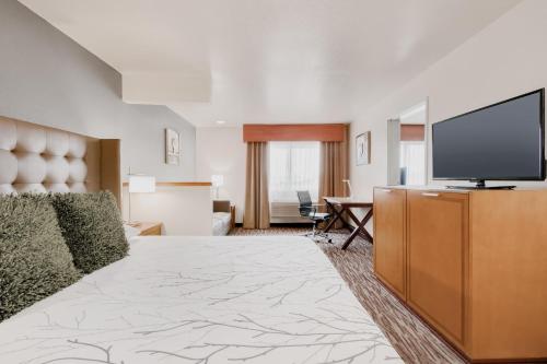 a large hotel room with a flat screen tv at Best Western PLUS Peppertree Airport Inn in Spokane