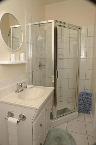 a bathroom with a shower and a sink and a mirror at Apartments and rooms with parking space Sumartin, Brac - 757 in Sumartin