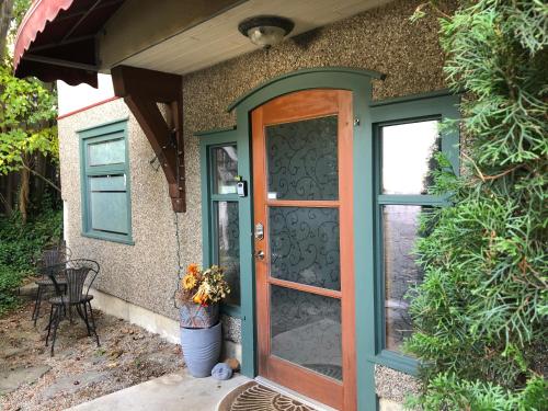 a door to a house with a table and chairs at Mistiso's Place Vacation Rentals in Nelson