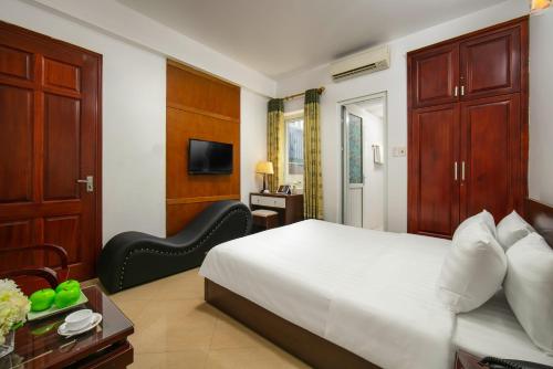 a hotel room with a bed and a chair at MIA SEN VỌNG HOTEL in Hanoi