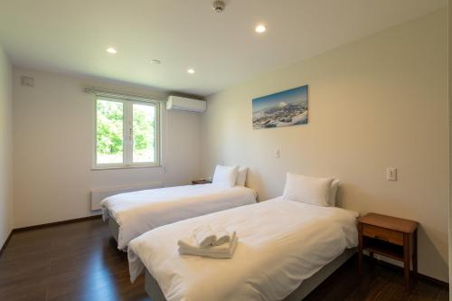 Postel nebo postele na pokoji v ubytování Annupuri Onsen Chalet