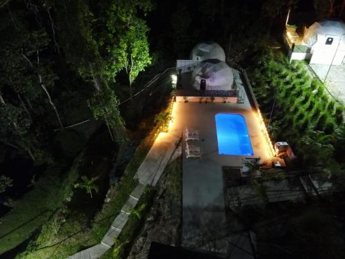 an overhead view of a house at night with a blue light at HOTEL, VILLAS y GLAMPINGS MYA -PUERTO VIEJO, Limon, CR in Puerto Viejo