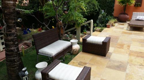 a group of chairs sitting on a patio at Pousada Recanto do Sal in Salinópolis