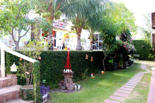 a garden with a fence and a red street light at Pousada Recanto do Sal in Salinópolis