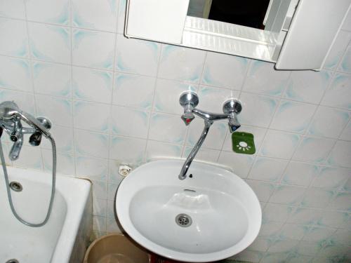 a bathroom with a white sink and a mirror at Apartments by the sea Pisak, Omis - 1003 in Mimice