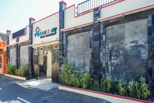 a building with a sign on the side of it at RedDoorz @ Umbul Ponggok Waterpark Klaten in Klaten