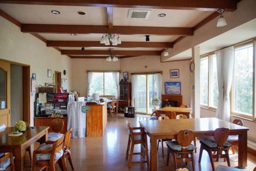 a living room with wooden tables and chairs at Stardew in Otari