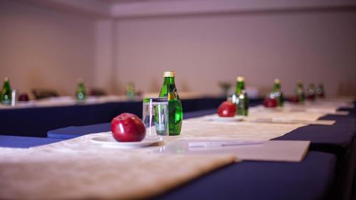 a long table with bottles and an apple on it at Holiday Inn Tuxpan - Convention Center by IHG in Tuxpan de Rodríguez Cano