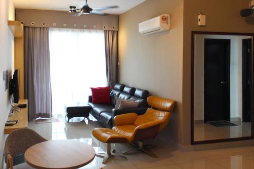a living room with a couch and a table at JOMSTAY Majestic Ipoh Suites in Ipoh