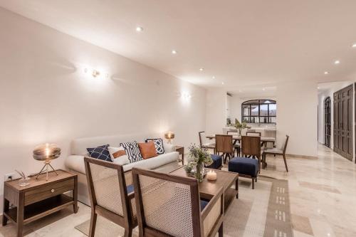 a living room with a couch and a table at Luxury Apartments in Centro San Miguel de Allende with Rooftop & Jacuzzi in San Miguel de Allende