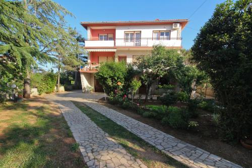 a house with a stone path in front of it at Apartments with parking space Silo, Krk - 18758 in Šilo