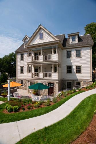 a large white house with a walkway at The Winstead Inn in Harwich