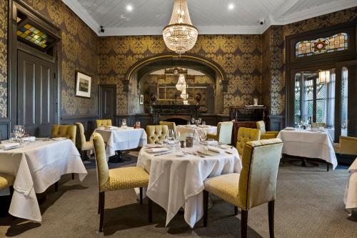 a dining room with tables and chairs and a chandelier at Lilianfels Blue Mountains Resort & Spa in Katoomba