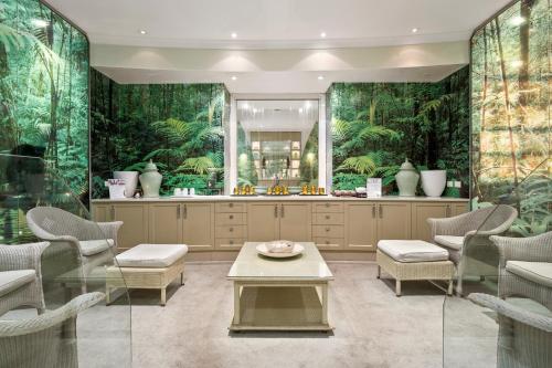 a kitchen with green walls and a table and chairs at Lilianfels Blue Mountains Resort & Spa in Katoomba