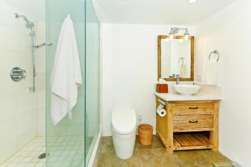 a bathroom with a shower and a toilet and a sink at Colony Surf #604 in Honolulu