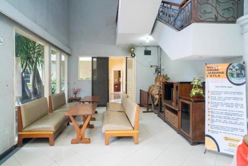 a living room with chairs and a table and a table at RedDoorz near Rumah Sakit Baptis Kediri in Kediri