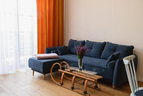 a living room with a blue couch and a coffee table at Pila Kvilda in Kvilda