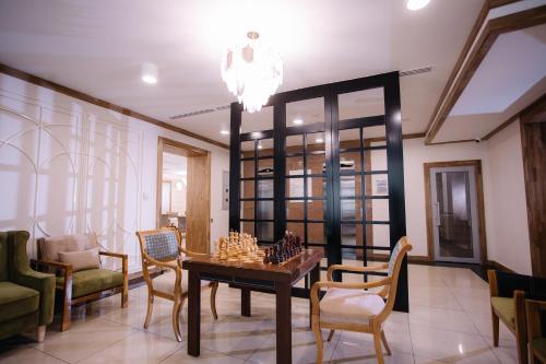a living room with a chess board on a table at Hotel Dastan Aktobe in Aktobe