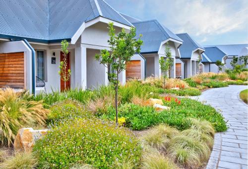 a row of houses with a garden in front at Knysna Hollow Country Estate in Knysna