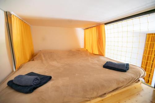 a bed in a room with two towels on it at Pila Kvilda in Kvilda