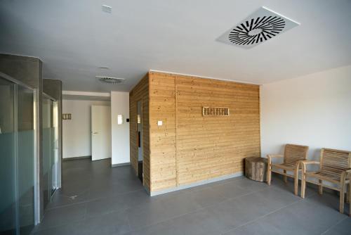 a hallway with chairs and a wooden wall at Pila Kvilda in Kvilda