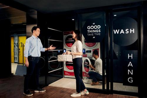 a man and a woman standing in front of a store at lyf Sukhumvit 8 Bangkok in Bangkok