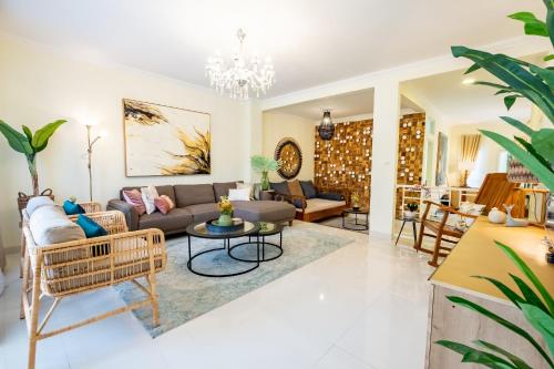 a living room with a couch and a table at Villa Siji Plemburan in Kejayan