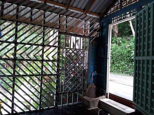 an entrance to a room with a glass door at Cozy Cabana1 in Roatán