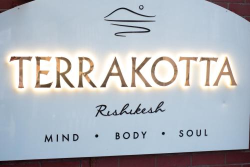 a sign that reads kerazatica and rattlesbestosbiologybiology at Terrakotta Rishikesh in Rishīkesh
