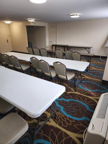 a conference room with white tables and chairs at Red Roof Inn Knoxville Central – Papermill Road in Knoxville