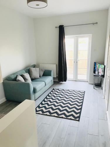 a living room with a couch and a rug at Nidd House Apartment in Harrogate