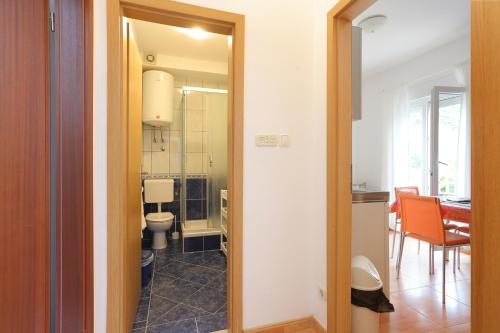 a hallway leading to a kitchen and a dining room at Apartments by the sea Podgora, Makarska - 18918 in Podgora