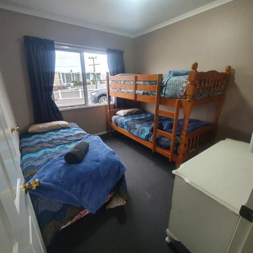 a bedroom with two bunk beds and a window at The Retreat Taupo in Taupo