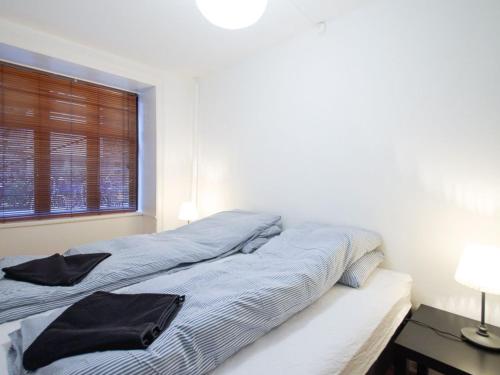 a bed with two pillows on it in a bedroom at Sanders Park - Lovely 1-Bdr Apt Close to Metro in Copenhagen