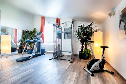 a gym with treadmills and exercise bikes in a room at Select Hotel A1 Bremen-Stuhr in Stuhr