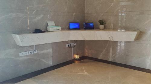 two monitors sitting on a shelf in a room at Holiday Inn Gurugram Sector 90 by IHG in Gurgaon