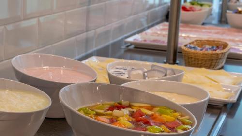 a group of bowls of food sitting on a counter at Holiday Inn Express - Krefeld - Dusseldorf by IHG in Krefeld