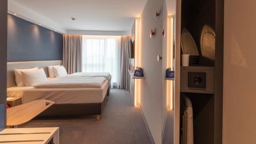 a hotel room with two beds and a window at Holiday Inn Express - Krefeld - Dusseldorf, an IHG Hotel in Krefeld