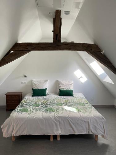 a bedroom with a large bed in a attic at Le coin des Halles dans le vignoble de Bourgueil in Bourgueil