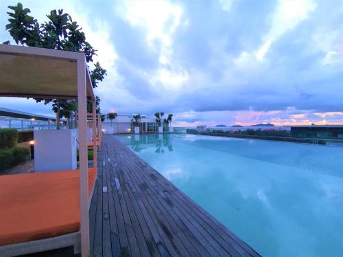 a large swimming pool on top of a building at KK City Sutera Avenue Opposite Imago by JR Homestay in Kota Kinabalu